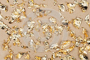 Gold luxury wealth holiday background. Gold foil flakes, patal, on the background. View from above. Finished work for