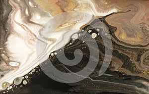 Gold marbling texture design. Beige and golden marble pattern. Fluid art.