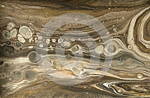 Gold marbling texture design. Beige and golden marble pattern. Fluid art.