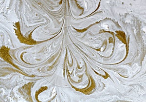 Gold marbling texture design. Beige and golden marble pattern. Fluid art. Dust, water.