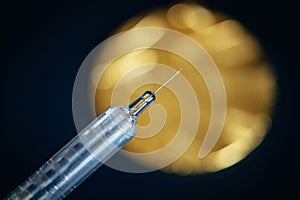 Gold medal and syringe. Doping and drugs in sport, concept photo. Black background