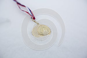 Gold medal in white backgrounds for winners in winter games