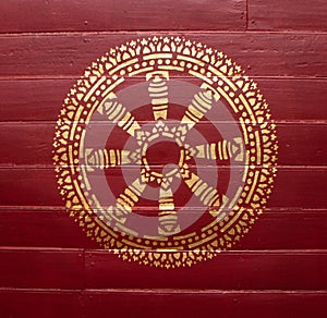 Gold medallion on reddish wood plate. photo
