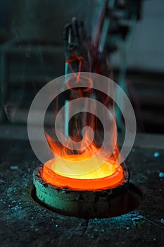 Gold is melted down in a refractory glass