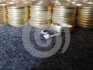 gold and metal business, engagement ring and marriage with gold coins stacked