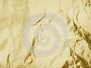 Gold metallic crumpled foil texture background