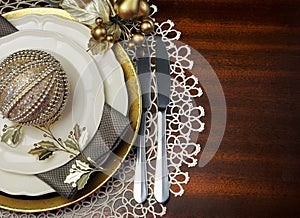 Gold metallic theme Christmas formal dinner table place setting with copy space