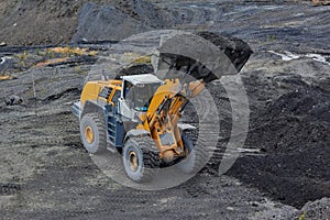 Gold mining in Susuman. An auto-loader with a full ladle