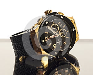 Gold modern watch on glass with reflection isolated