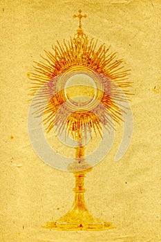 Gold monstrance on grunge paper