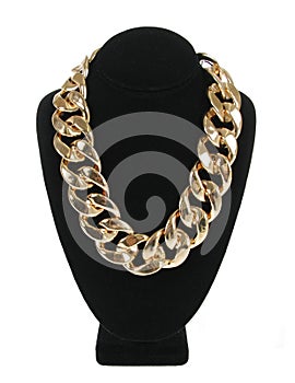 Gold necklace chain on velvet stand isolated on white, fashion jewelry