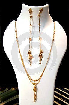 Gold necklaces on necklace display stand