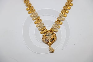 Gold necklaces on white background