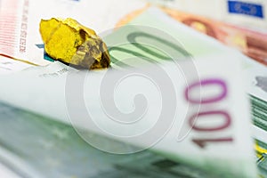 Gold nugget on euro banknotes