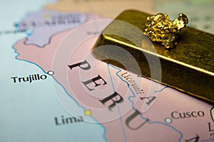 Gold nugget and gold bar and map of Peru