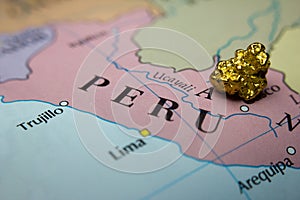 Gold nugget and gold bar and map of Peru