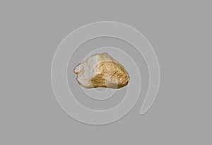 Gold nugget on a gray background