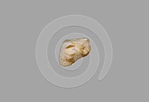 Gold nugget on a gray background