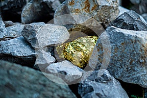 Gold nugget and grey granite stone photo