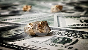 Gold nugget lies on dollars