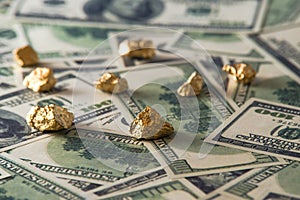 Gold nugget lies on dollars