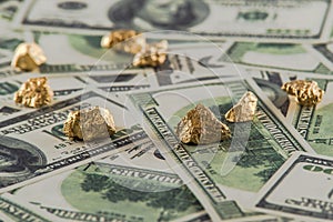 Gold nugget lies on dollars