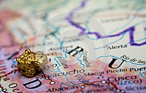 Gold-nugget and a map of Peru