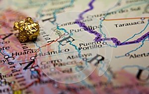 Gold-nugget and a map of Peru