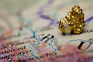 Gold-nugget and a map of Peru