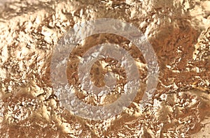 Gold nugget surface with broan stains.