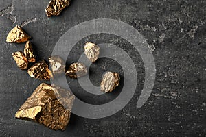 Gold nuggets on dark background photo