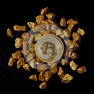 Gold nuggets and Gold Bitcoin Coin on black background. Bitcoin cryptocurrency.
