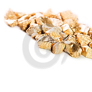 Gold nuggets on white background.