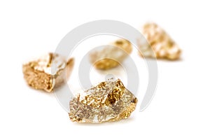 Gold nuggets on white background. photo