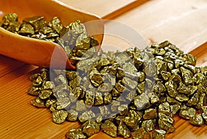 Gold nuggets and wooden scoop