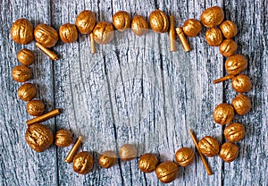 Gold nuts and gilt sticks on the background of old wooden panels, Christmas background