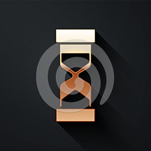 Gold Old hourglass with flowing sand icon isolated on black background. Sand clock sign. Business and time management