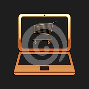 Gold Online shopping concept. Shopping cart on screen laptop icon isolated on black background. Concept e-commerce