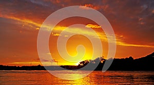 Gold and Orange coloured Nimbostratus cloudy coastal Sunset Seascape. Australia