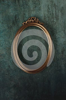 Gold oval frame on a wall