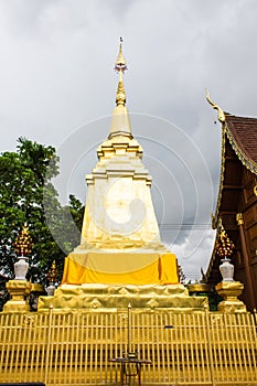 Gold pagoda with teak wood chapel, lanna style