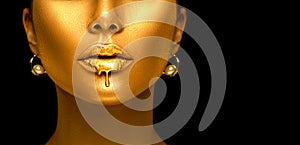 Gold paint drips from the lips, golden liquid drops on beautiful model girl`s mouth, creative abstract makeup