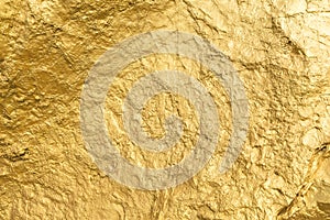 Gold paint stone or rock texture glitter abstract on background