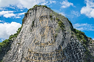 Gold painting of buddha statue on cliff at Cheechan mountain