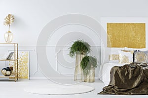 Gold painting in elegant bedroom