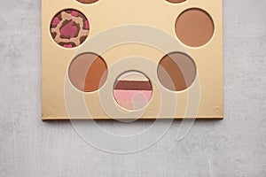 Gold palette with bronzer for makeup. beauty and fashion concept