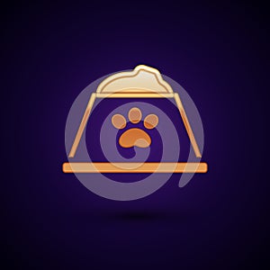 Gold Pet food bowl for cat or dog icon isolated on black background. Dog or cat paw print. Vector