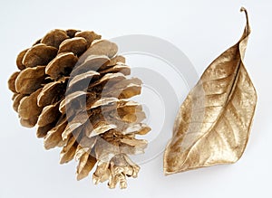Gold pinecone and gold leaf. Christmas decoration. isolated on white background