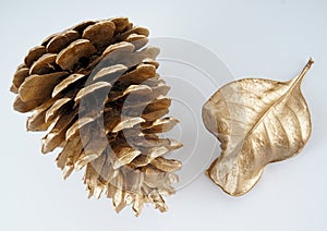 Gold pinecone and gold leaf. Christmas decoration. isolated on white background