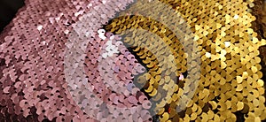 Gold  pink and multi-colored sparkles on the fabric. Rainbow blurred background. Shiny  sparkling in the sun  multi-colored